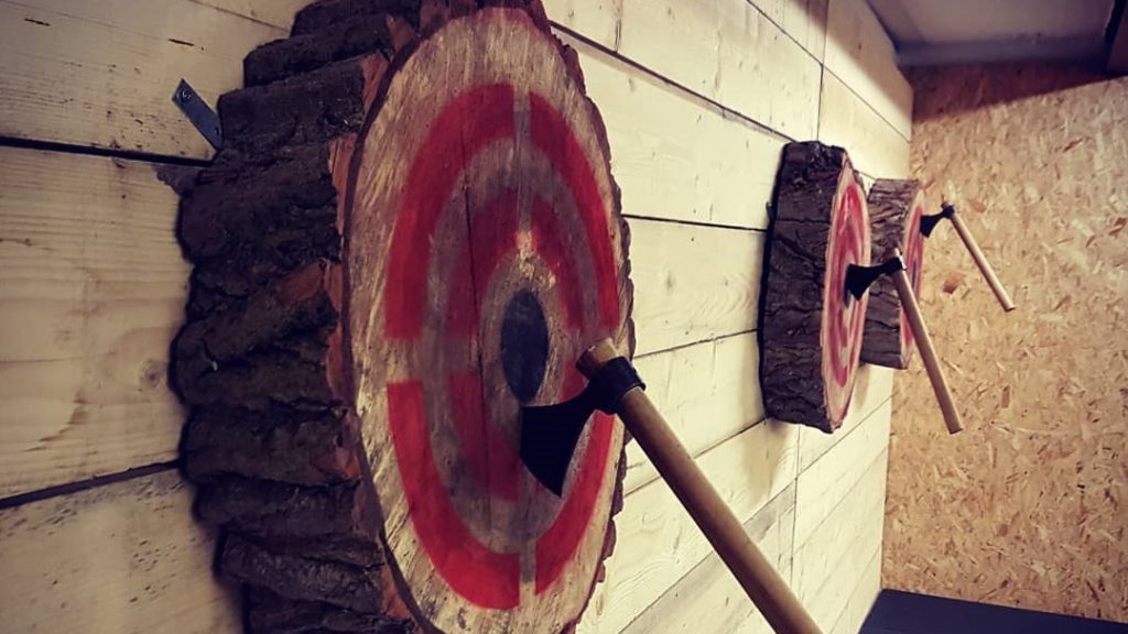 Axe throwing targets with hatchets embedded at Valhalla Axe Throwing in Sheffield.