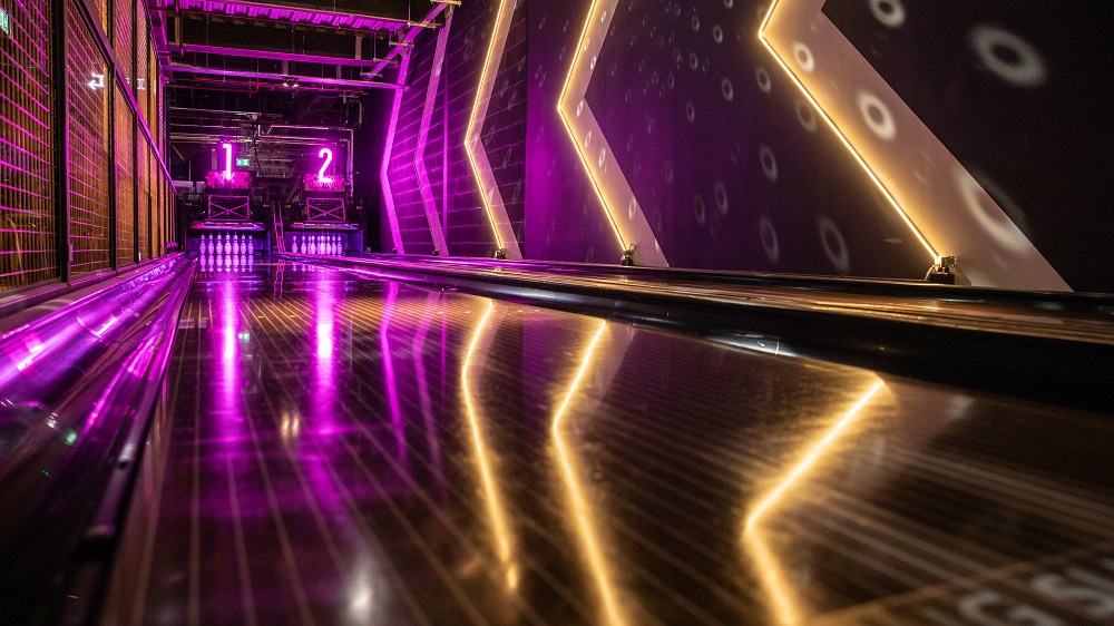 Neon lit bowling lanes at Lane7. Activity Bars in Edinburgh