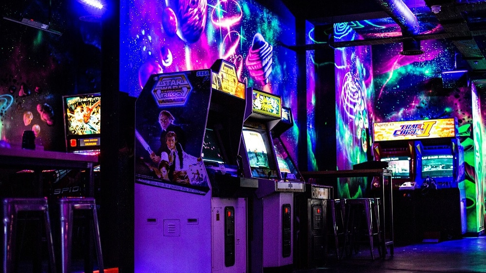 Graffiti clad retro gaming bar NQ64 in Edinburgh. Activity Bar with arcade games and consoles