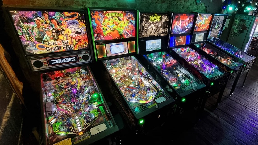 Row of pinball machines at Retroids Arcade Bar
