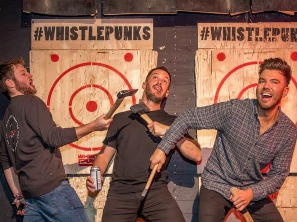 Friends enjoying axe throwing at Whistle Punks