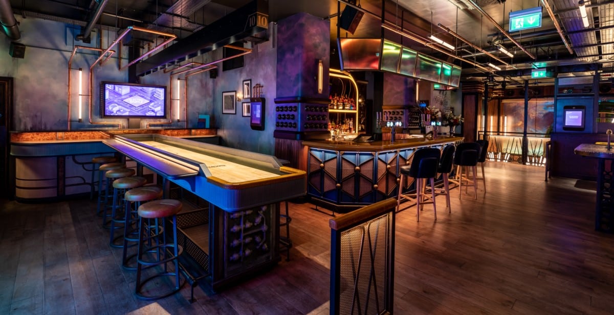 Shuffleboard table and bar area at Electric Shuffle Canary Wharf