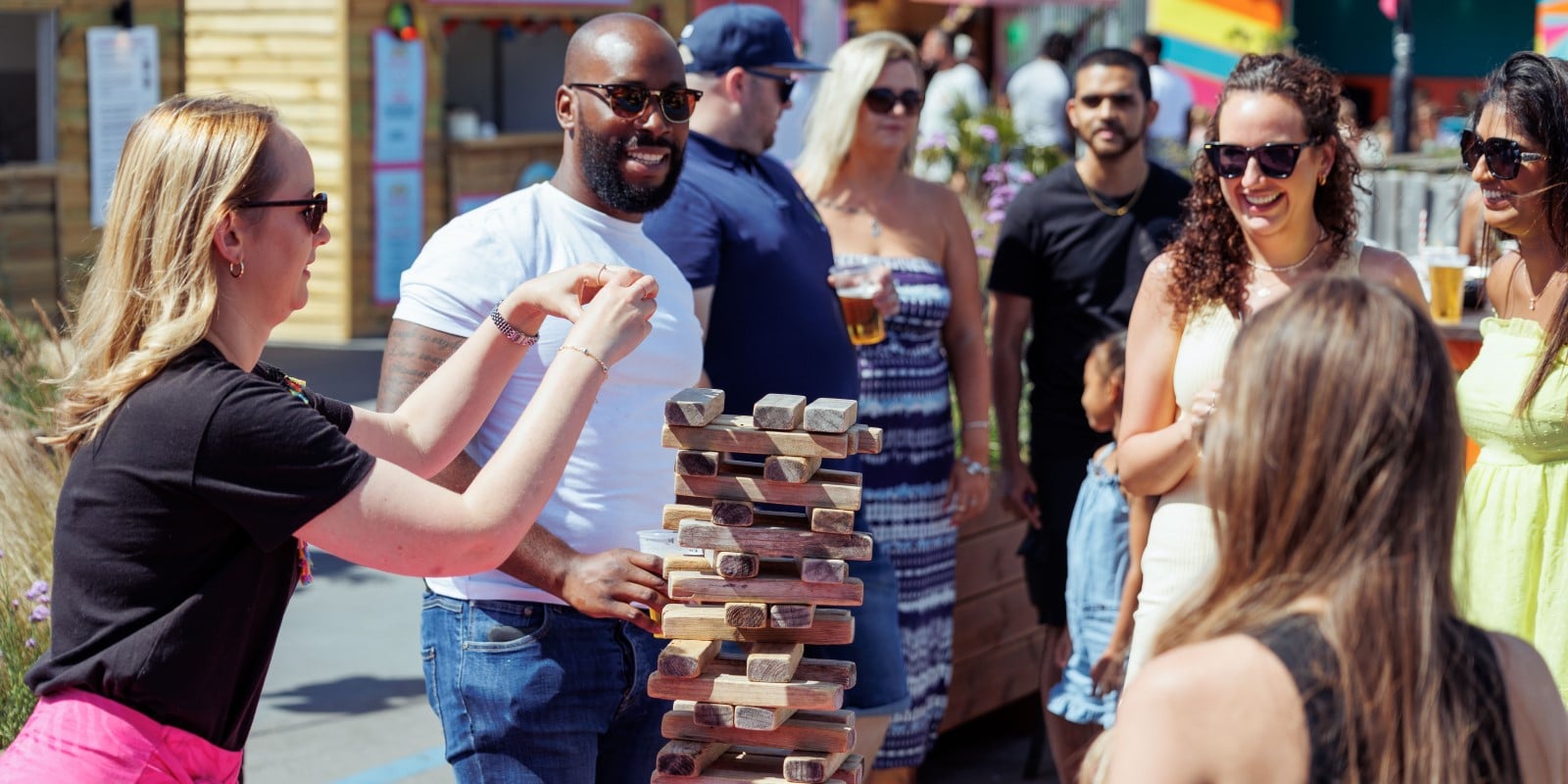 Friends playing giant stacking blocks (like Jenga)